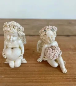 Lille engel med rosa blomsterhjerte
